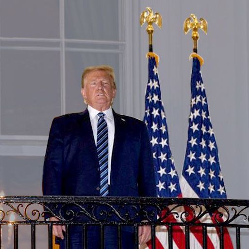 us president donald trump looks out from the truman balcony as he arrives at the white house upon his return from walter reed medical center, where he underwent treatment for covid 19, in washington, dc, on october 5, 2020 photo by nicholas kamm  afp photo by nicholas kammafp via getty images