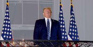 us president donald trump looks out from the truman balcony as he arrives at the white house upon his return from walter reed medical center, where he underwent treatment for covid 19, in washington, dc, on october 5, 2020 photo by nicholas kamm  afp photo by nicholas kammafp via getty images