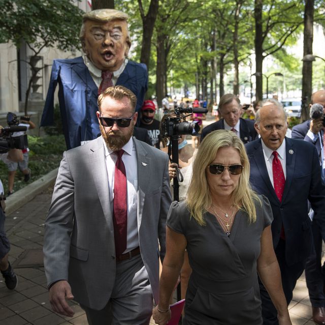 washington, dc   july 27 protestors hold an effigy of former president donald trump as rep marjorie taylor greene r ga, rep louie gohmert r tx and rep matt gaetz r fl arrive for a news conference outside the us department of justice on july 27, 2021 in washington, dc the group of far right conservatives held a news conference to demand answers from attorney general merrick garland on the status of january 6 prisoners photo by drew angerergetty images
