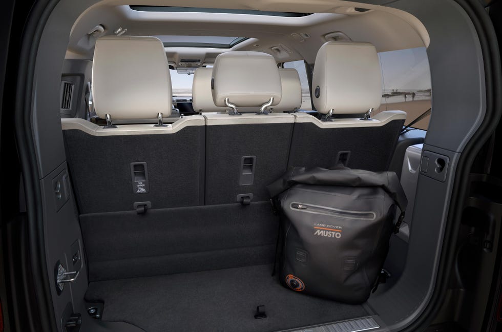 the truck of the defender 130 with all three rows of seats up and a bag in the back