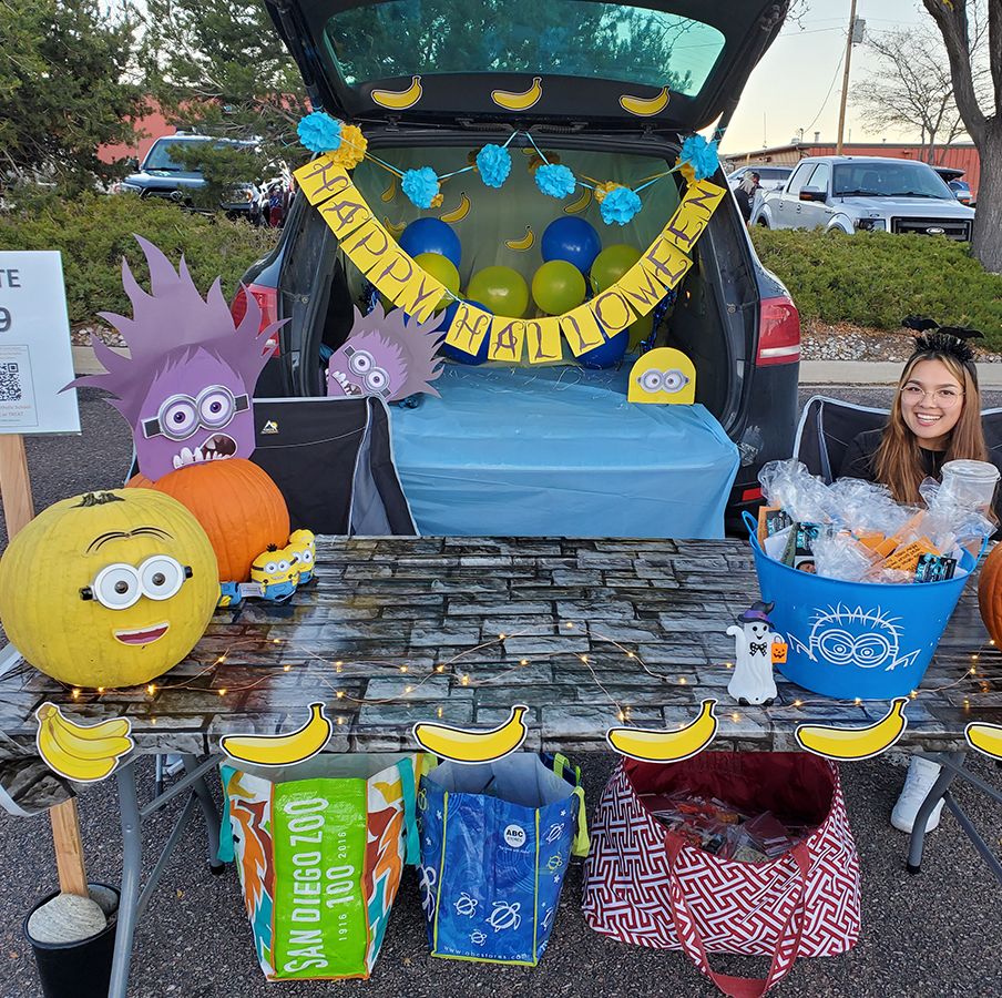 a car decked out for trunk or treat in minions theme with minions pumpkins, bananas and minion cutouts