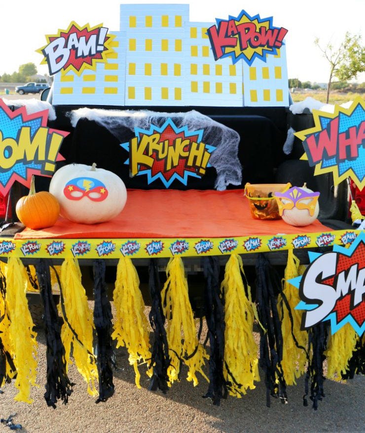 a car decked out for trunk or treat in a superhero theme with comic words like krunch and smash