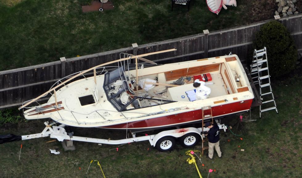 watertown   april 20 an aerial view of the boat where dzhokhar a tsarnaev was found hiding after a massive manhunt is seen in the backyard of a franklin street home april 20, 2013 in watertown, massachusetts tsarnaev was taken into custody after a daylong manhunt that began when he and his brother, and co conspirator in the boston marathon bombing, killed a massachusetts institute of technology police officer and wounded another in cambidge dzhokhar tsarnaev then car jacked a vehicle and fled into watertown where another shootout accurred tsarnaev's brother tamerlan was killed in the cambridge shootout photo by darren mccollestergetty images   local caption