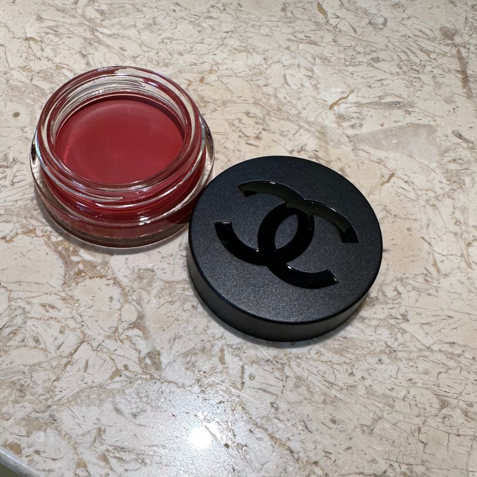 a couple of red containers with a black symbol on a white surface