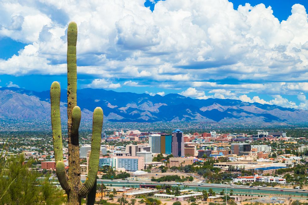 tucson aerial skyline view with dramatic clouds and a cactus