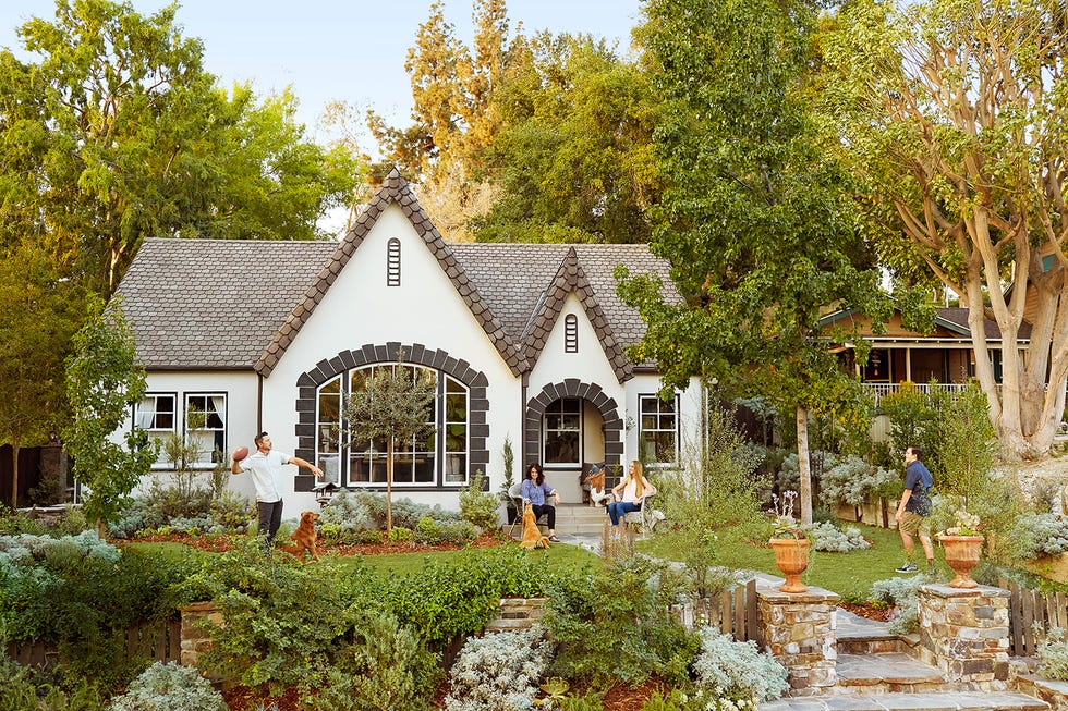 white tudor cottage with gray shingle roof