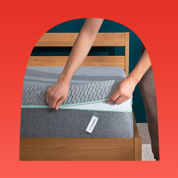 unzipping mattress cover and tuft and needle mattress on wooden bedframe