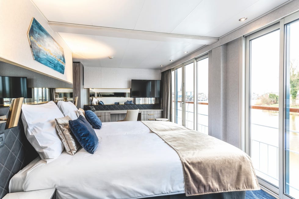 Modern hotel room with twin beds large windows and contemporary decor