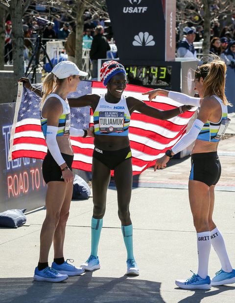 Aliphine Tuliamuk celebrates with Kellyn Taylor and Stephanie Bruce.