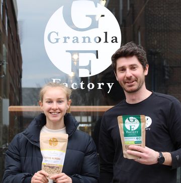 a man and a woman holding granola and smiling