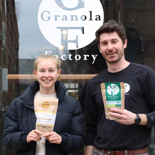 a man and a woman holding granola and smiling