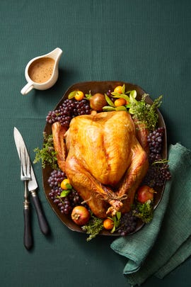 roasted turkey on a platter with fruits