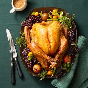 roasted turkey on a platter with fruits