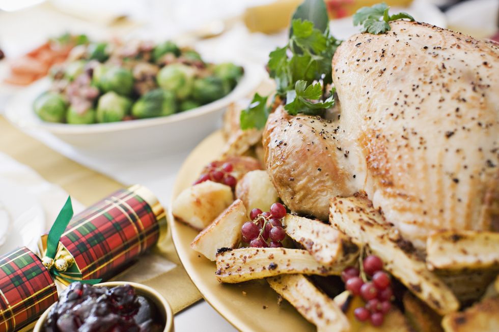 turkey, cranberries and christmas cracker on table