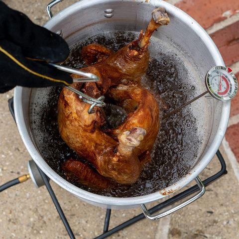 turkey being fried in oil in king kooker aluminum pot