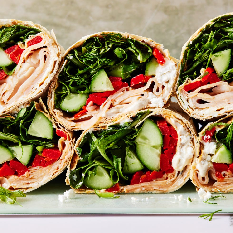 tortilla wrap with turkey, spinach, cucumbers, and red peppers
