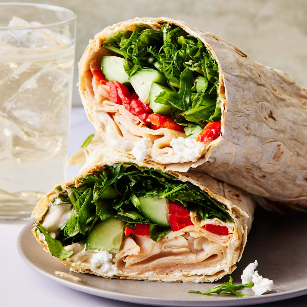 tortilla wrap with turkey, spinach, cucumbers, and red peppers