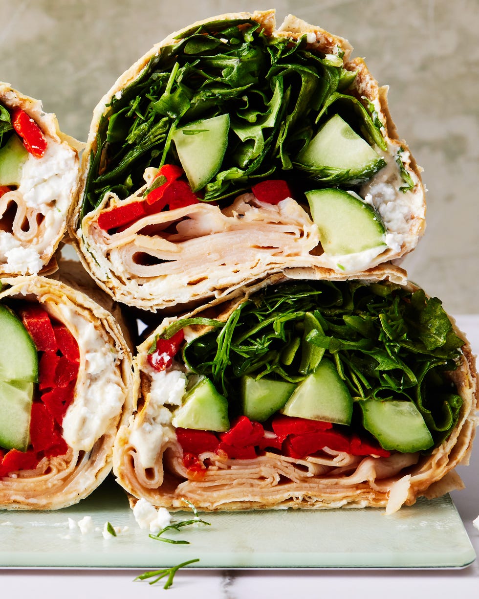 tortilla wrap with turkey, spinach, cucumbers, and red peppers