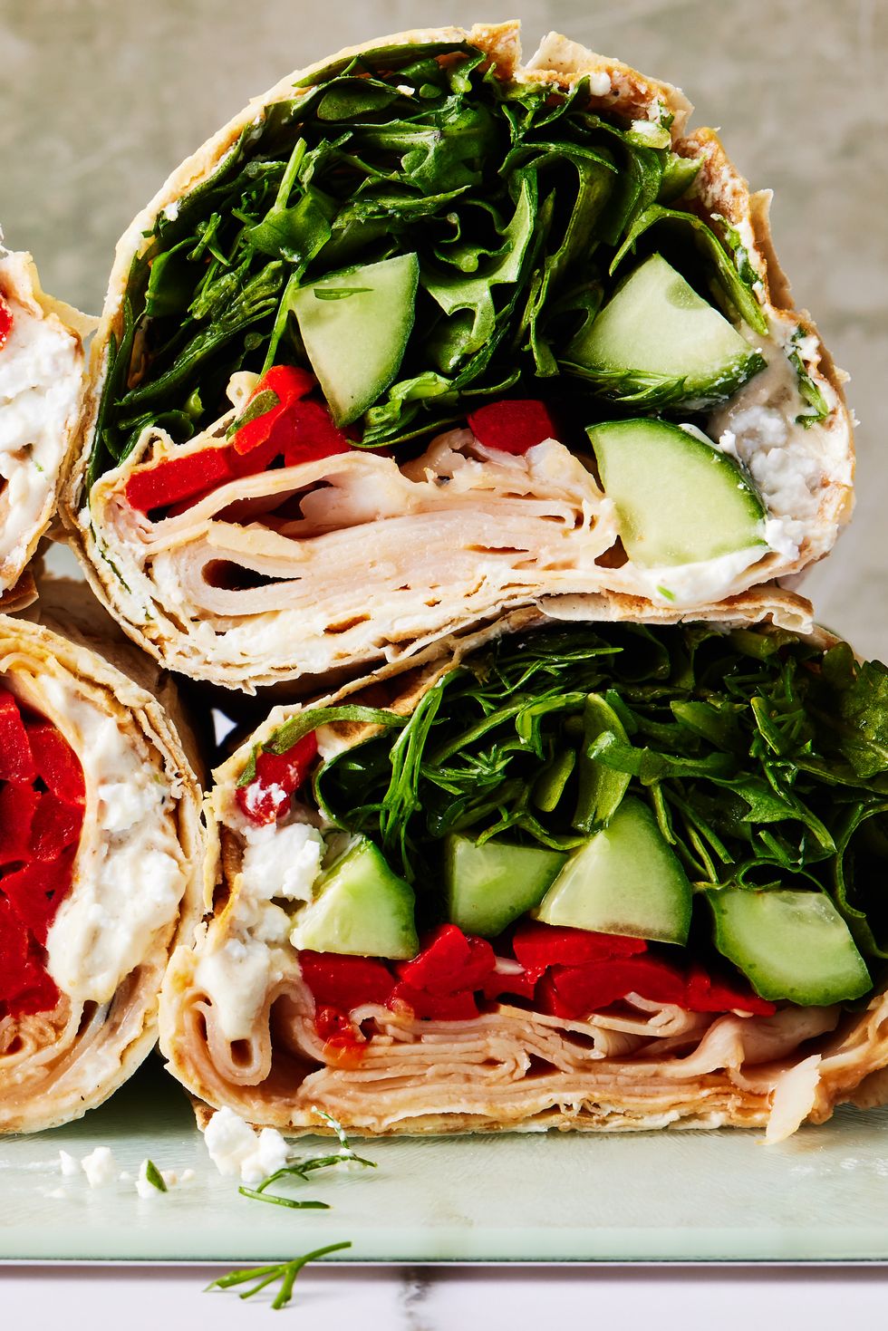tortilla wrap with turkey, spinach, cucumbers, and red peppers