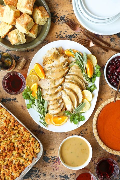 slow cooker turkey breast on platter with oranges and gravy