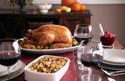 turkey, stuffing, and cranberry dishes on table