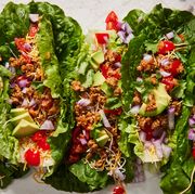 turkey taco lettuce wraps topped with cilantro, red onion, avocado, and tomatoes