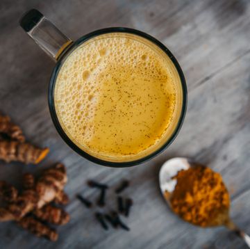 turmeric latte drink close up top view turmeric root and powder superfood concept, healthy food lifehack