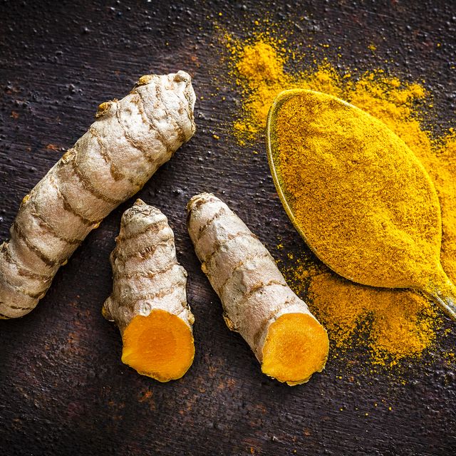 spices turmeric roots and powder shot from above