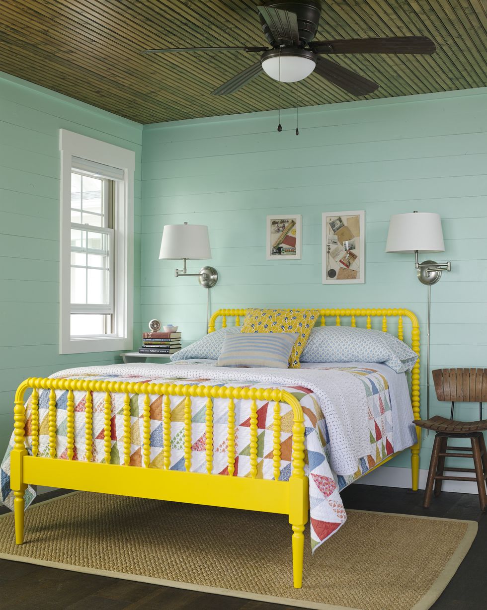 Bedroom with turquoise walls and yellow bed