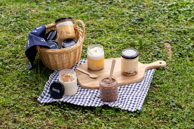 a picnic table with a basket of food and a basket of food