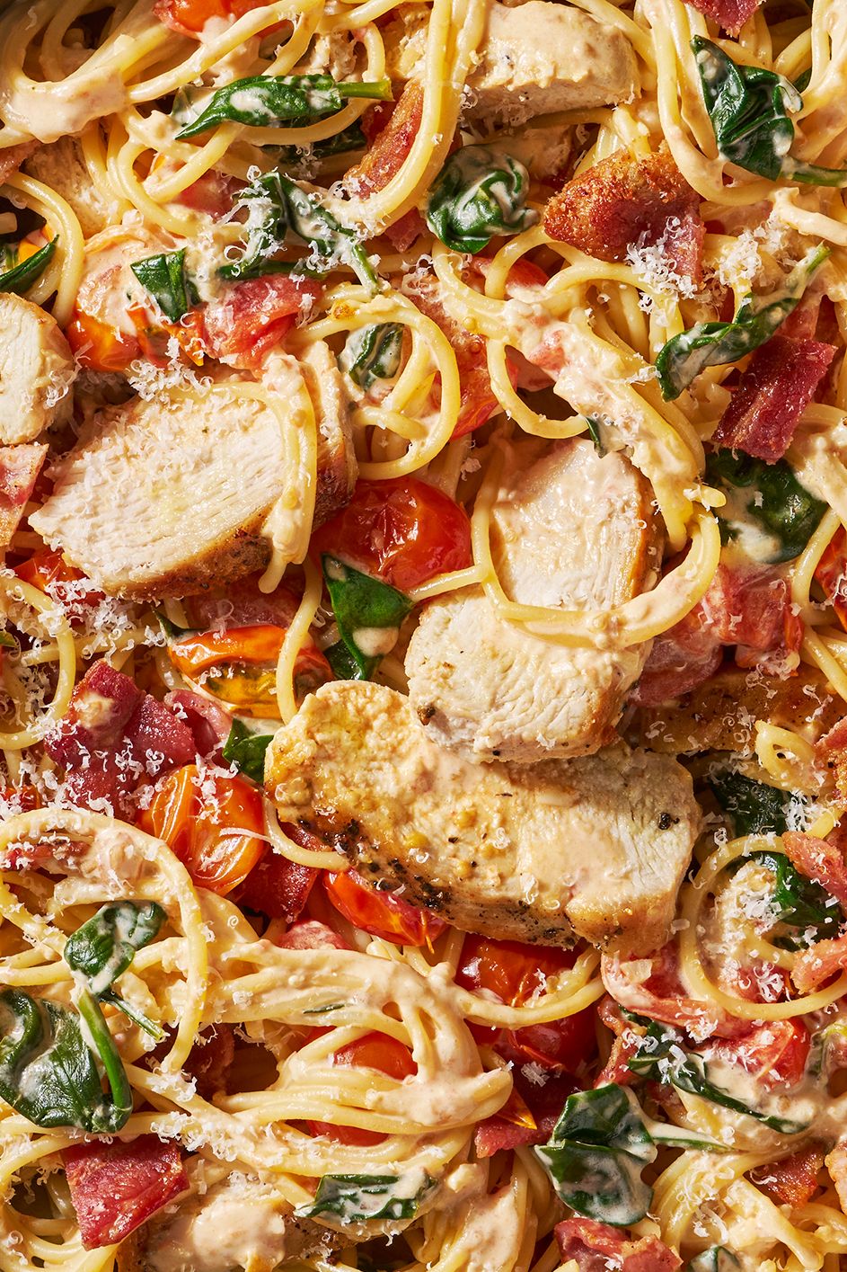 angel hair pasta with sliced chicken, tomatoes and basil