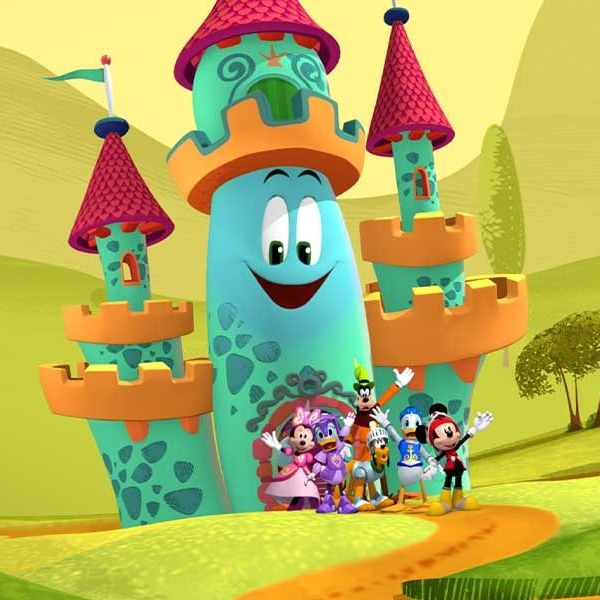 mickey, donald, goofy, daisy and minnie stand in front of a castle shaped funhouse in a promotional image for mickey mouse funhouse, a good housekeeping pick for best toddler tv shows