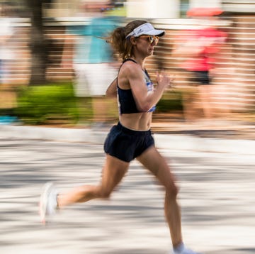 a woman running on a street a woman running on a street