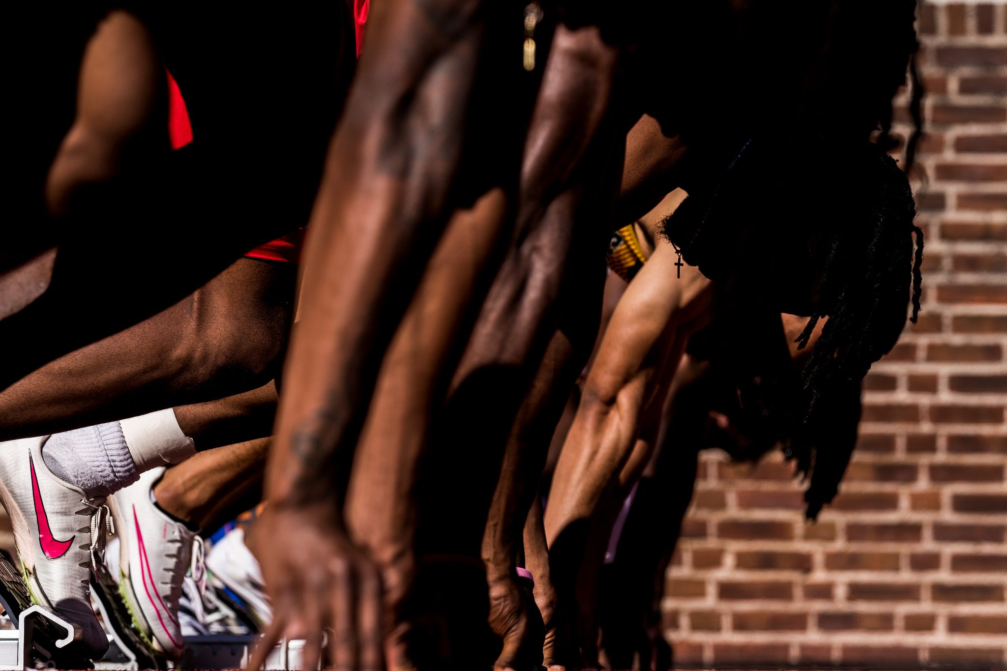 RWD a group of runners line up in blocks before a sprint race