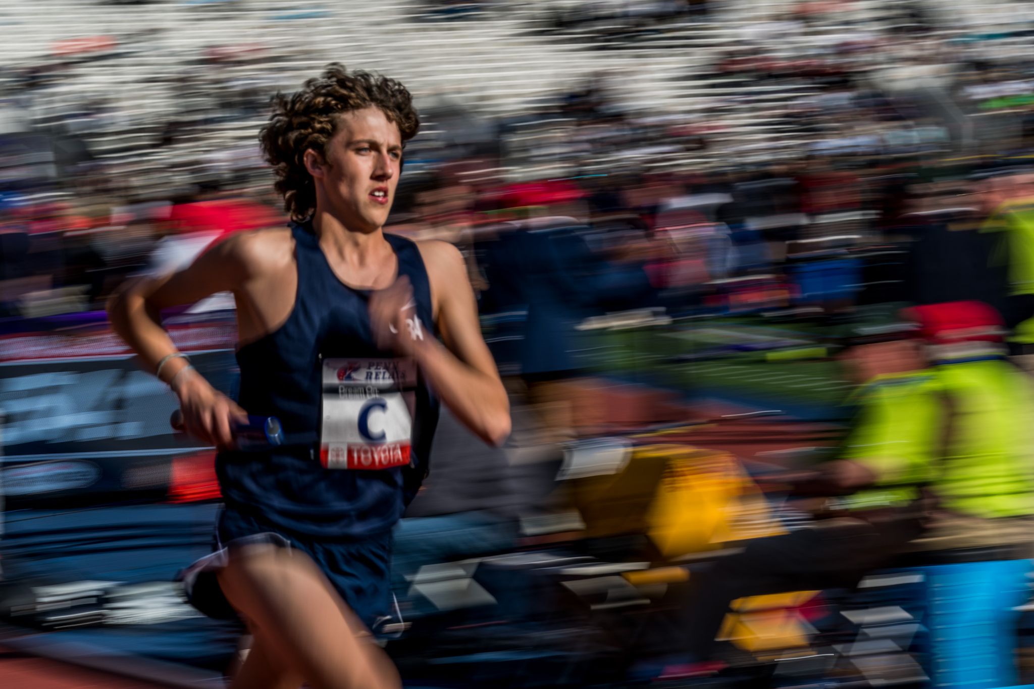 a person running in a race with a blurred background