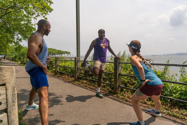runners stretching by river