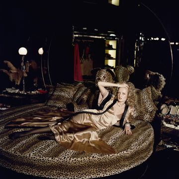 english model twiggy stretches out on a leopardskin bed at biba's kensington store, 1971