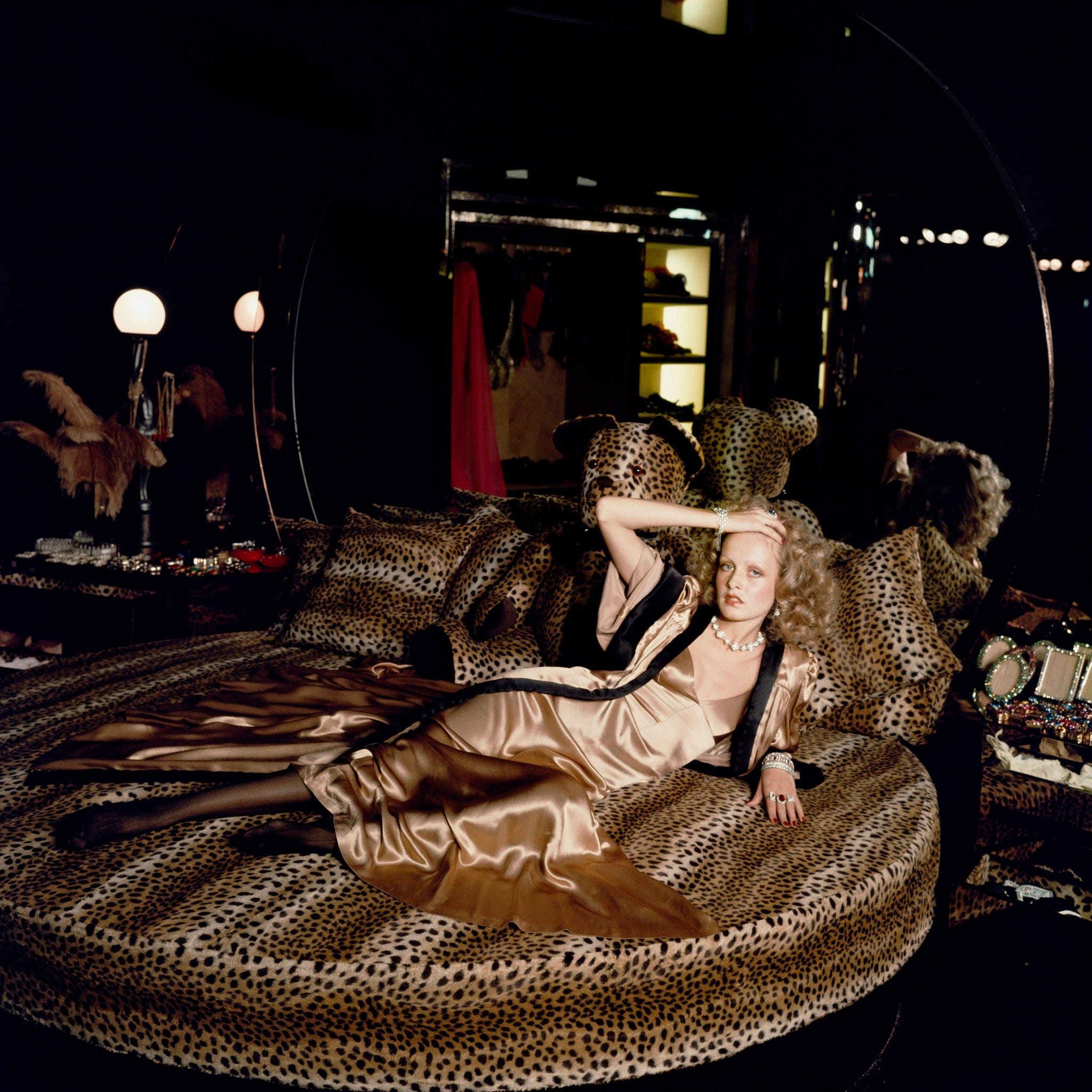 english model twiggy stretches out on a leopardskin bed at biba's kensington store, 1971