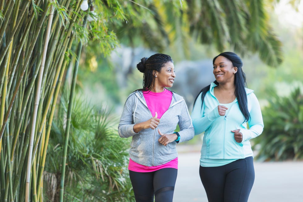 Two African American women jogging together