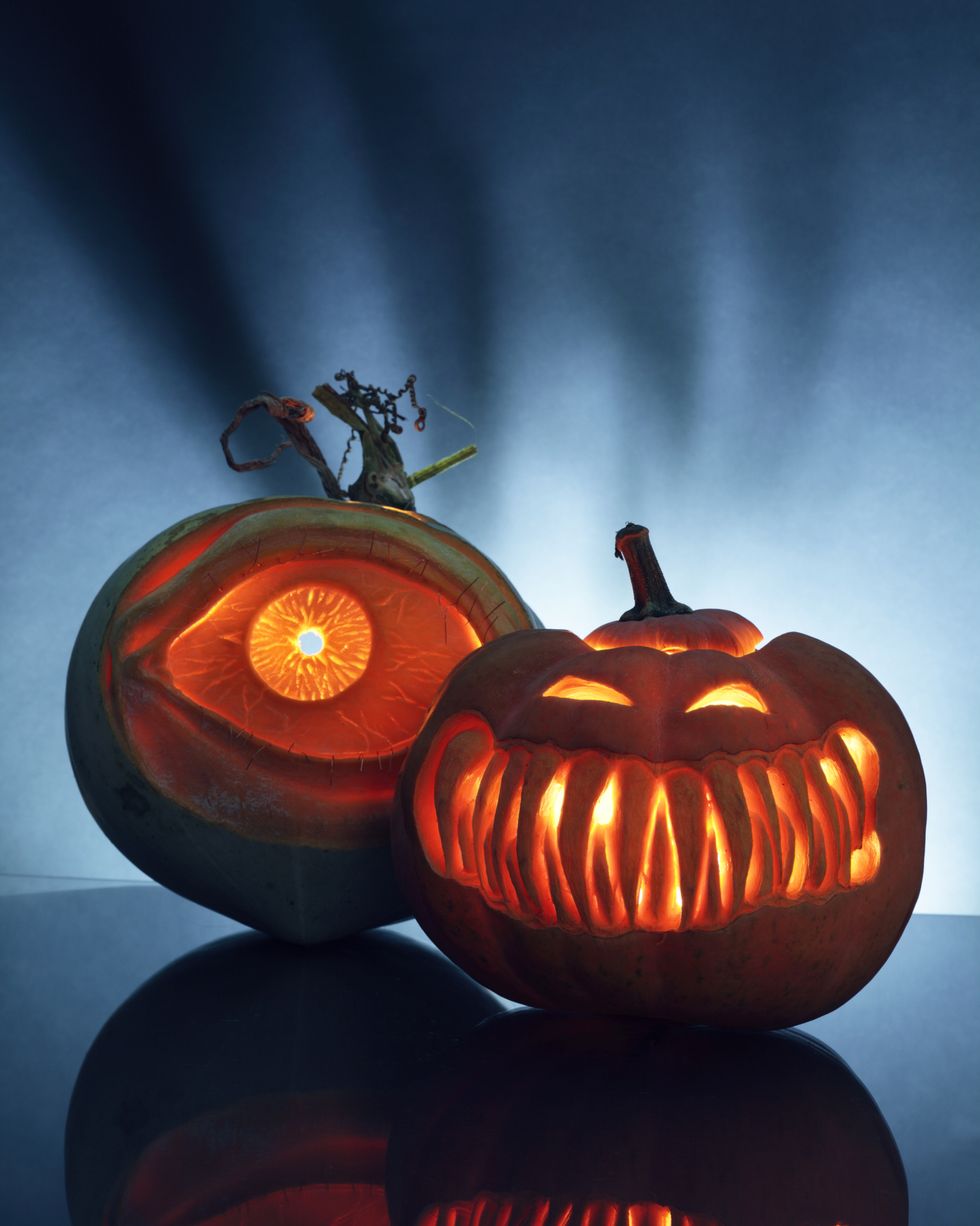 two artistically carved jack o lantern pumpkins