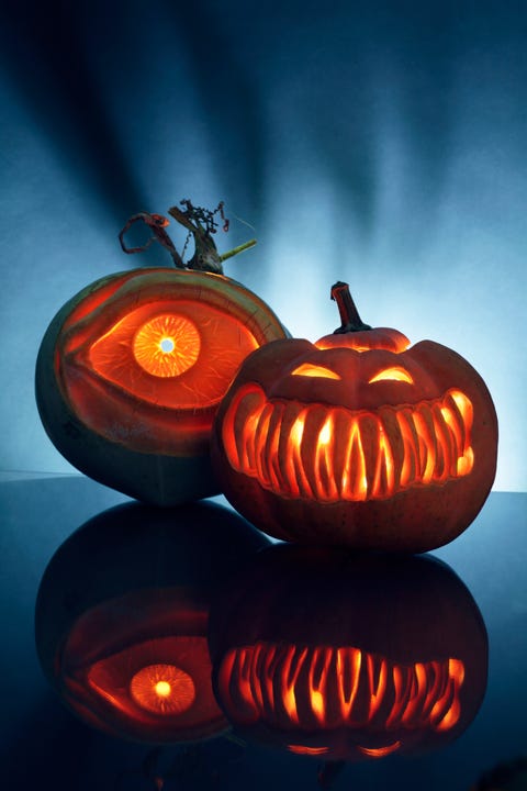 two artistically carved jack o lantern pumpkins