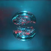 two bubbles of air, blue and red, forming two halves of a sphere
