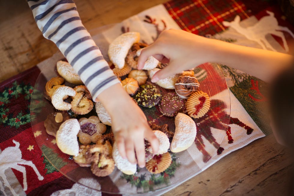 two children choosing traditional german christmas cookies