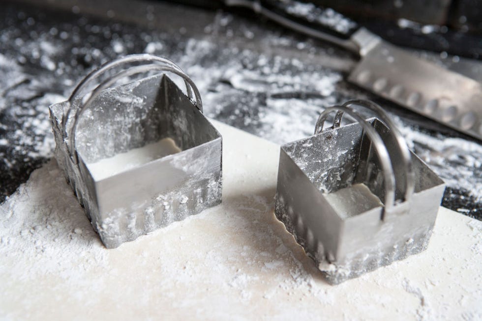two cookie cutters on dough
