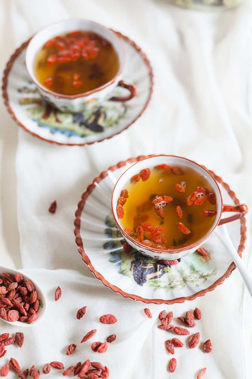 Two cups of green jasmine tea with dried Goji berries, Lycium barbarum