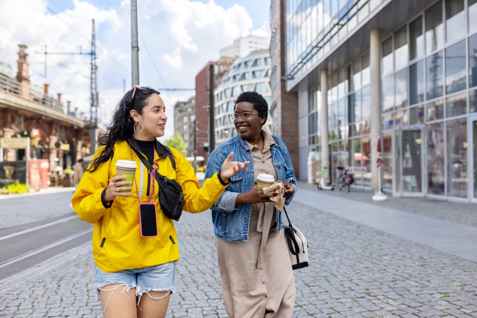 two female friends walking outside in the city