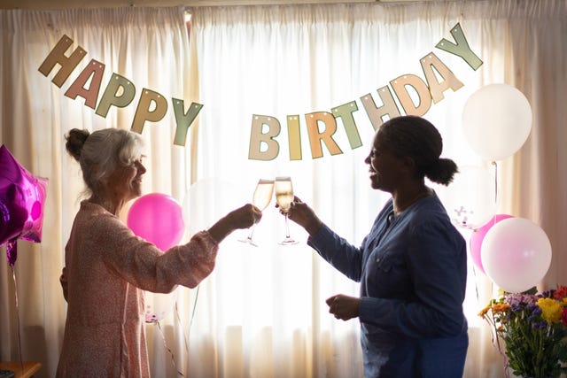 two friends celebrating a birthday with champagne