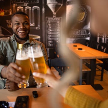 Two friends drinking beer and talking in a bar two friends drinking beer and talking in a bar