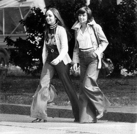 Two girls in jeans walking