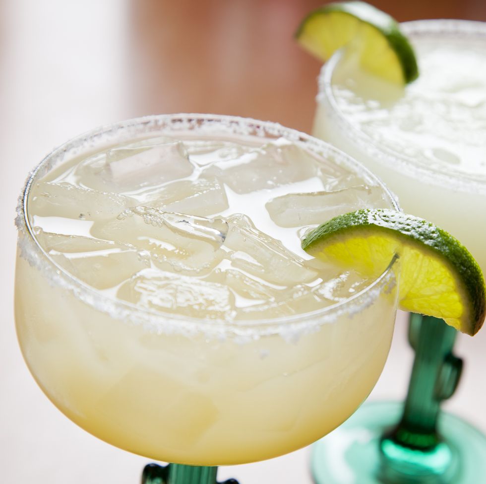 two glasses of classic margarita on the rocks and blended
